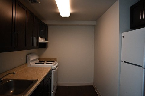 a small kitchen with a stove and a refrigerator